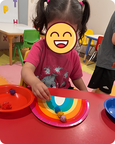 Child making a rainbow craft